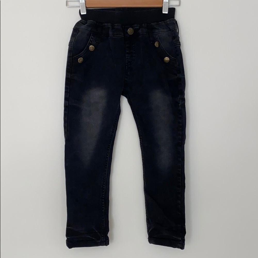 Distressed jeans w/ embellished back pockets.